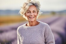 Headshot Portrait Photography Of A Satisfied Mature Woman Wearing A Cozy Sweater Against A Lavender Field Background. With Generative AI Technology