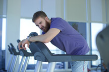 Tired Exhausted Young Man Feeling Bad, Unhealthy, Unwell During Run On Treadmill In The Gym