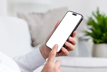 Poster - Woman holds modern smartphone, dressed in a white shirt, standing in living room. Isolated mobile screen for app or web page presentation