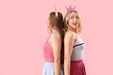 Poster - Young sisters in crowns on pink background