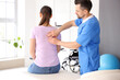 © Pixel-Shot - Male physiotherapist working with young woman in rehabilitation center