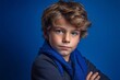 © Markus Schröder - Close-up portrait photography of a satisfied kid male crossing the arms against a royal blue background. With generative AI technology