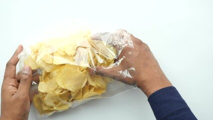 Wall Mural - men holding a open potato chips packet 