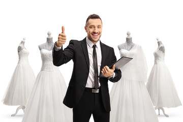 Wall Mural - Man with a clipboard and documents showing thumbs up at a bridal shop