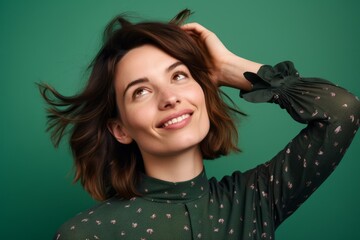 Wall Mural - Close-up portrait photography of a satisfied girl in her 30s scratching one's head in a gesture of confusion against a mint green background. With generative AI technology