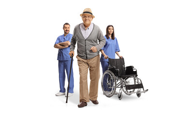 Wall Mural - Elderly man with a walking cane in front of team of health care workers
