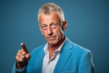 Poster - Headshot portrait photography of a glad mature man raising a finger as if having an idea against a soft blue background. With generative AI technology