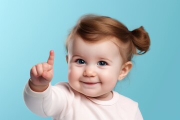 Close-up portrait photography of a glad girl in her 20s making a i'm thinking gesture with the finger on the temple against a baby blue background. With generative AI technology