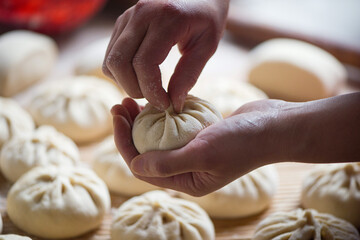 Homemade people making raw steamed buns. Delicious baozi,