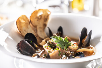 Wall Mural - Detailed view of a mussels and seafood soup in a deep designer plate