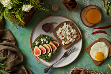 Breakfast Toasts With Cottage Cheese, Fig Slices, And Pomegranate - Top View