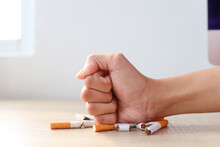 Hand Fist Smash Or Punch On Cigarette. Smoking Reduction Campaign In World No Tobacco Day.