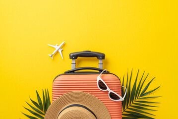 summer vacation concept. top view photo of orange suitcase with sunhat and sunglasses on it with pal
