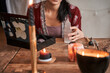 © Yakobchuk Olena - Brunette fortune teller holding crystals at wooden table
