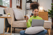 © Daenin - African American woman working at her home. girl studying online
