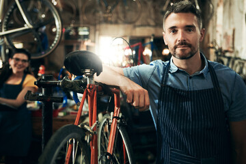 Wall Mural - Serious, portrait and technician man in bicycle shop working in store or cycling workshop for repair. Face, bike mechanic and confident male person, business owner or mature professional with pride