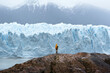 A man posing on the ice formation of the Perito Moreno glacier, Argentina