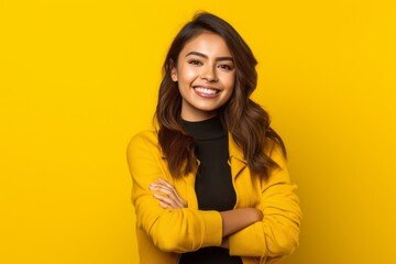 Wall Mural - Medium shot portrait photography of a grinning girl in her 20s crossing the arms against a bright yellow background. With generative AI technology