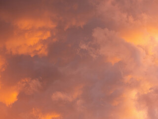 Dramatic sky with clouds. Mysterious abstract background pattern texture. Many yellow and orange tones and patterns of clouds.