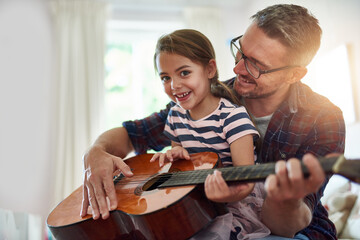 Sticker - Father, guitar and teaching a girl in portrait with happiness at home for fun or love or bonding. Music, acoustic and instrument with parent and daughter for learning or care with music together.