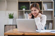 © wichayada - Business woman using calculator for do math finance on wooden desk in office and business working background, tax, accounting, statistics and analytic research concept...