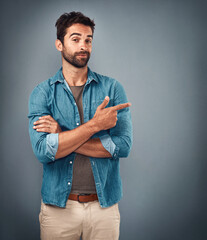 Point, hands and portrait of man in studio on gray background for announcement, news and information. Fashion, mockup space and male person with pointing hand sign for promotion, choice and decision