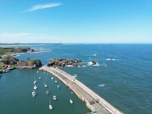 Aerial View Of Dunbar Harbour With Boats Docked And A Clear Blue Sky Background. Dunbar Scotland. 