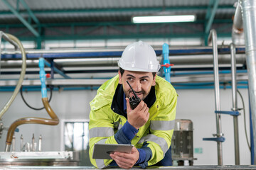 Wall Mural - Engineers or factory managers wearing safety helmet inspect the machines in the production line. Utility inspector check machine and test the system to meet the standard. machine, maintenance.