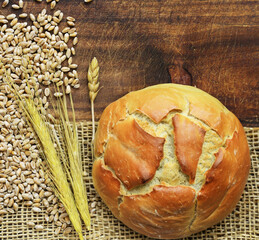 Poster - fresh organic bread on wooden table