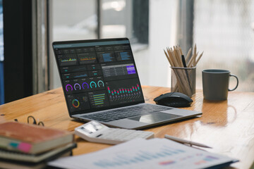Business data analysis software on a dashboard screen. The investment application displays business sales and profits on the computer screen, providing advice for marketing planning decisions.