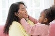 © amorn - Asian mother and daughter playing together at home. Happy African American little girl kid playing with mom. Happy family spending time together