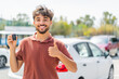 © luismolinero - Young Arabian handsome man holding car key at outdoors with thumbs up because something good has happened