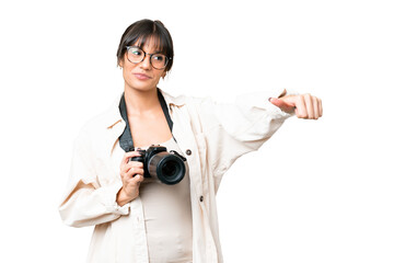 Wall Mural - Young photographer caucasian woman over isolated chroma key background giving a thumbs up gesture