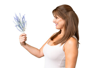 Wall Mural - Middle age caucasian woman holding lavender over isolated background with happy expression