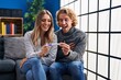 © Krakenimages.com - Young couple holding pregnancy test result smiling and laughing hard out loud because funny crazy joke.