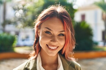 Wall Mural - Young caucasian woman smiling confident standing at park