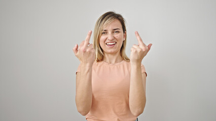 Poster - Young blonde woman doing bad gesture with fingers over isolated white background