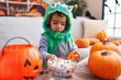 © Krakenimages.com - Adorable hispanic boy having halloween party holding sweets at home