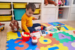 © Krakenimages.com - Adorable hispanic boy playing supermarket game sitting on floor at kindergarten