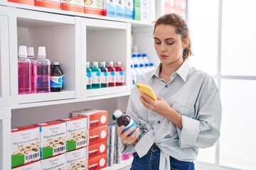 Sticker - Young woman customer using smartphone holding medication bottle at pharmacy