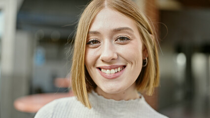 Poster - Young blonde woman smiling confident standing at coffee shop terrace