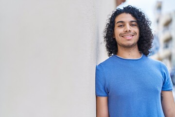 Sticker - Young latin man smiling confident standing at street