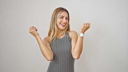 Wall Mural - Young blonde woman smiling confident standing with winner expression over isolated white background