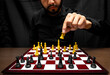 © Narayan - latin man with beard challenging in chess game, chess concept