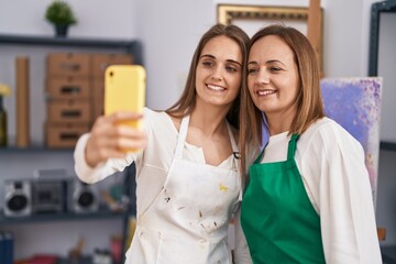 Poster - Two women artists smiling confident make selfie by smartphone at art studio