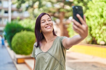 Canvas Print - Young beautiful hispanic woman smiling confident making selfie by the smartphone at park