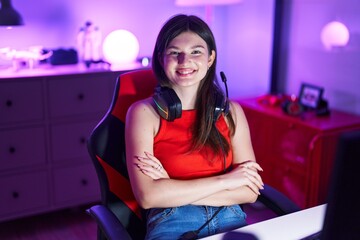 Poster - Young caucasian woman streamer smiling confident sitting with arms crossed gesture at gaming room