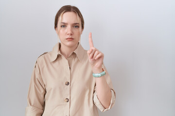 Sticker - Young caucasian woman wearing casual shirt pointing with finger up and angry expression, showing no gesture