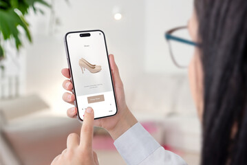 Wall Mural - girl shopping online on ecommerce website. looking for shoes for a night out. modern app interface