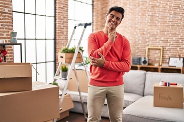 Sticker - Hispanic man moving to a new home smiling looking confident at the camera with crossed arms and hand on chin. thinking positive.